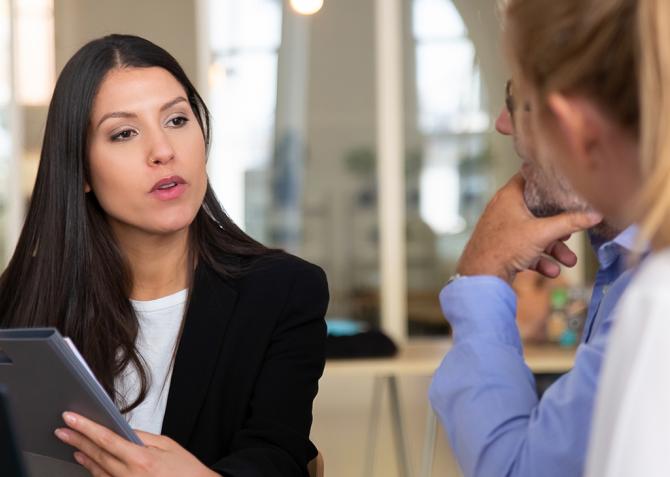 Three business professionals having a discussion.