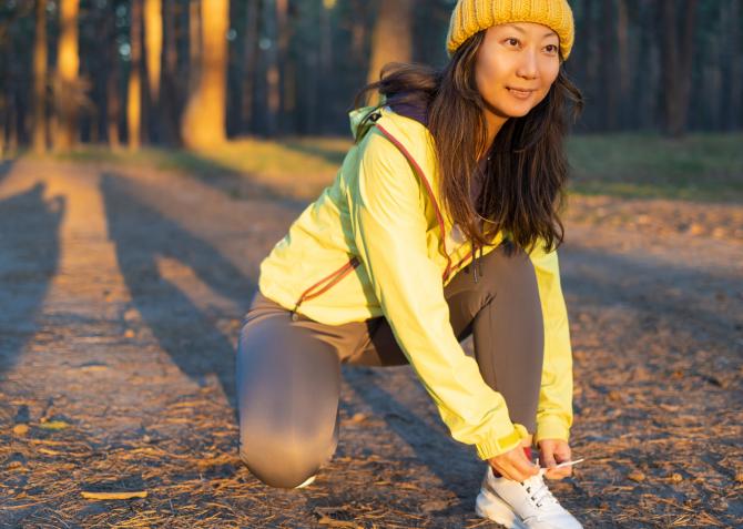 Female runner tying shoe