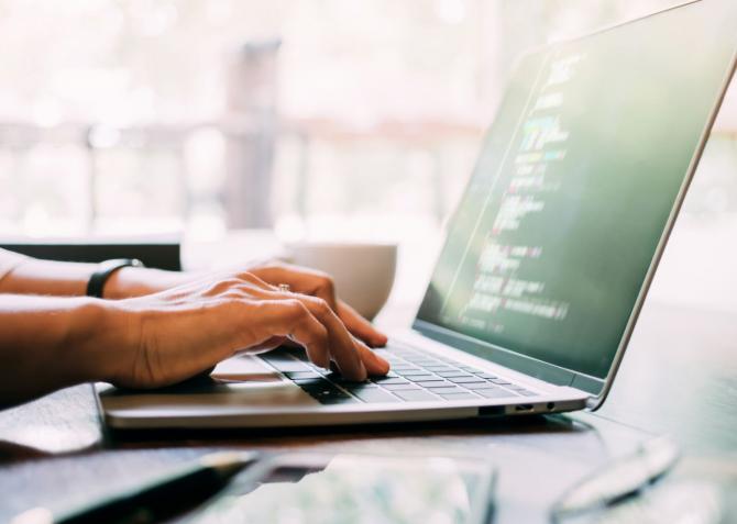 woman working on her business website on laptop