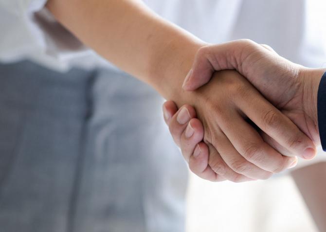 workers at an office shaking hands