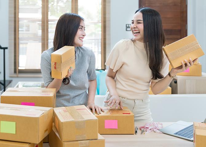 Two entrepreneurs share a laugh as they work.